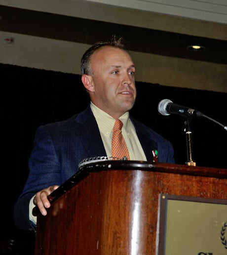 Buck Davidson stands at a podium during the USEA Annual Meeting in 2011.