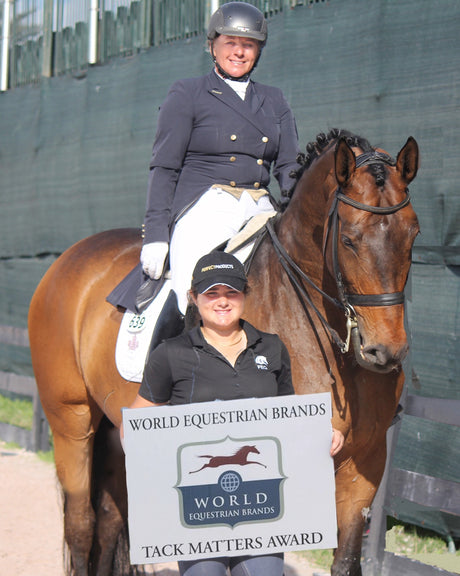 Evi Strasser, riding Rigaudon Tyme, is presented with the World Equestrian Brands Tack Matters Award with her daughter and fellow dressage rider Tanya Strasser (front)