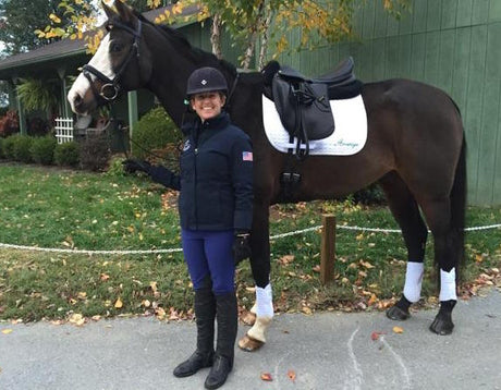 World Equestrian Brands sponsored rider Sharon White poses with her dark bay horse wearingan Amerigo saddle and Vespucci bridle